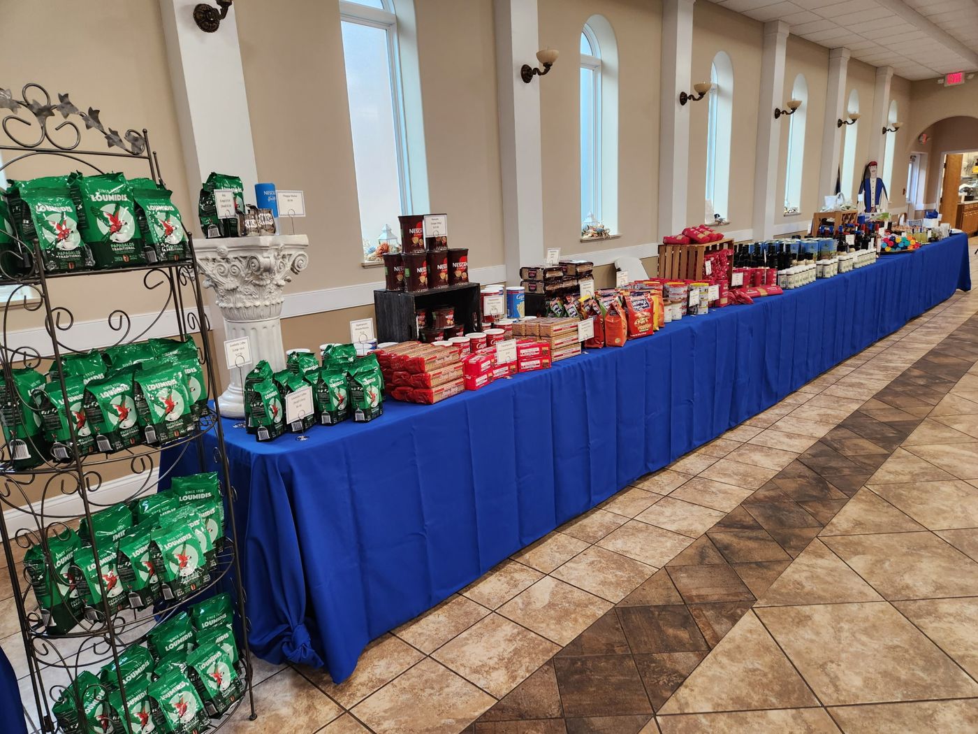 Market table lined with Greek coffee, Nescafe, and cookies